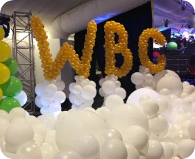 Balloon letters "WBC" above white balloons.