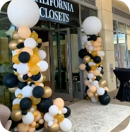 Balloon columns outside store entrance.
