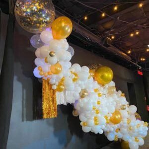 Gold and white balloon decoration display.