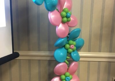 Colorful balloon flowers decoration against wall.