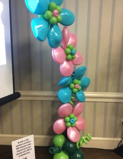 Colorful balloon flowers decoration against wall.