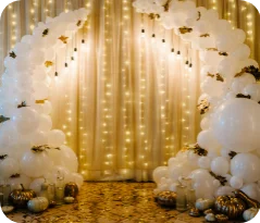Balloon arch with lights and decorations.
