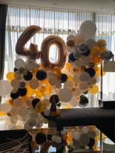 Balloon arrangement with number 40 decoration.