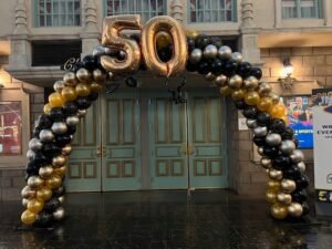 Balloon arch with "50" in gold.