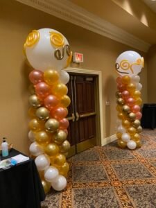 Balloon columns with gold and white design.