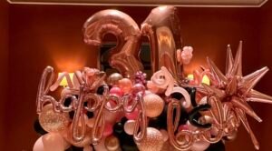 Rose gold balloon display celebrating 21st birthday.