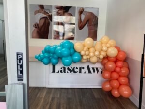 Colorful balloons in front of LaserAway sign.