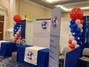 Travel fair booth with patriotic balloon decorations.