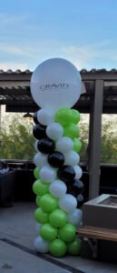 Balloon tower with "Gravity" logo outdoors.