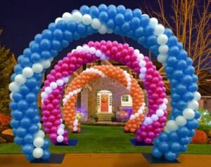 Colorful balloon arches in front of house.