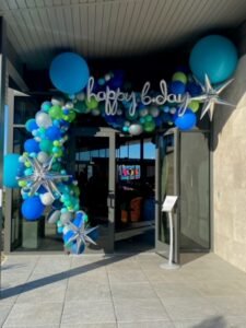 Birthday entrance with colorful balloon decorations.