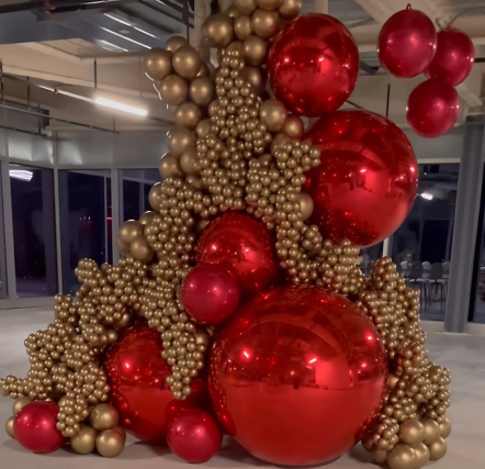 Red and gold balloon sculpture in building.