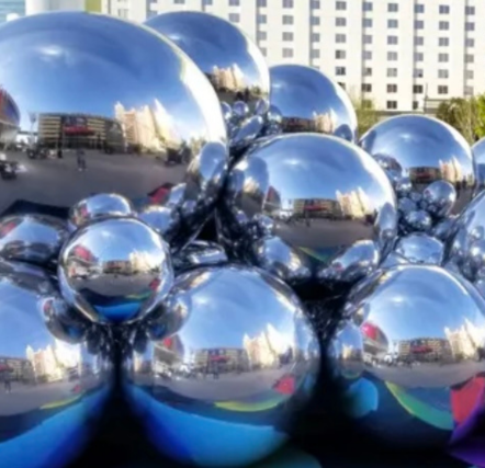 Reflective silver spheres in urban setting.
