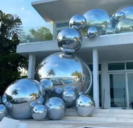 Reflective spheres on modern house exterior.