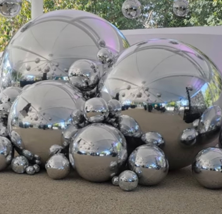 Cluster of large reflective silver spheres.