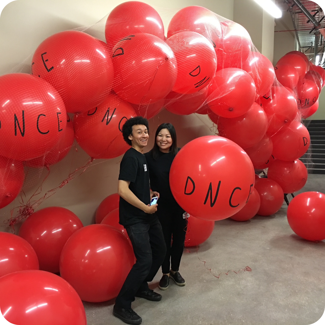 Two people with large red balloons. Two people with large red balloons.