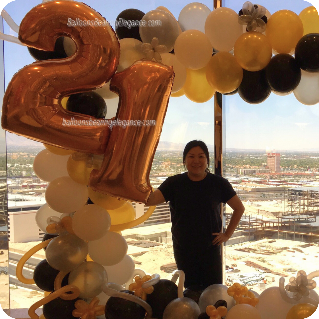 Person with balloon arrangement and city view. Person with balloon arrangement and city view.