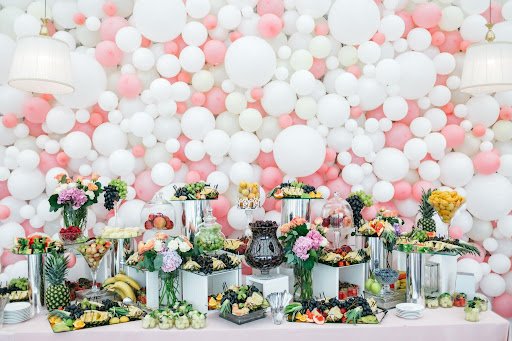 Elegant celebration balloons, Las Vegas décor with a stylish table of sweets and fruits, creating a luxurious and inviting party atmosphere